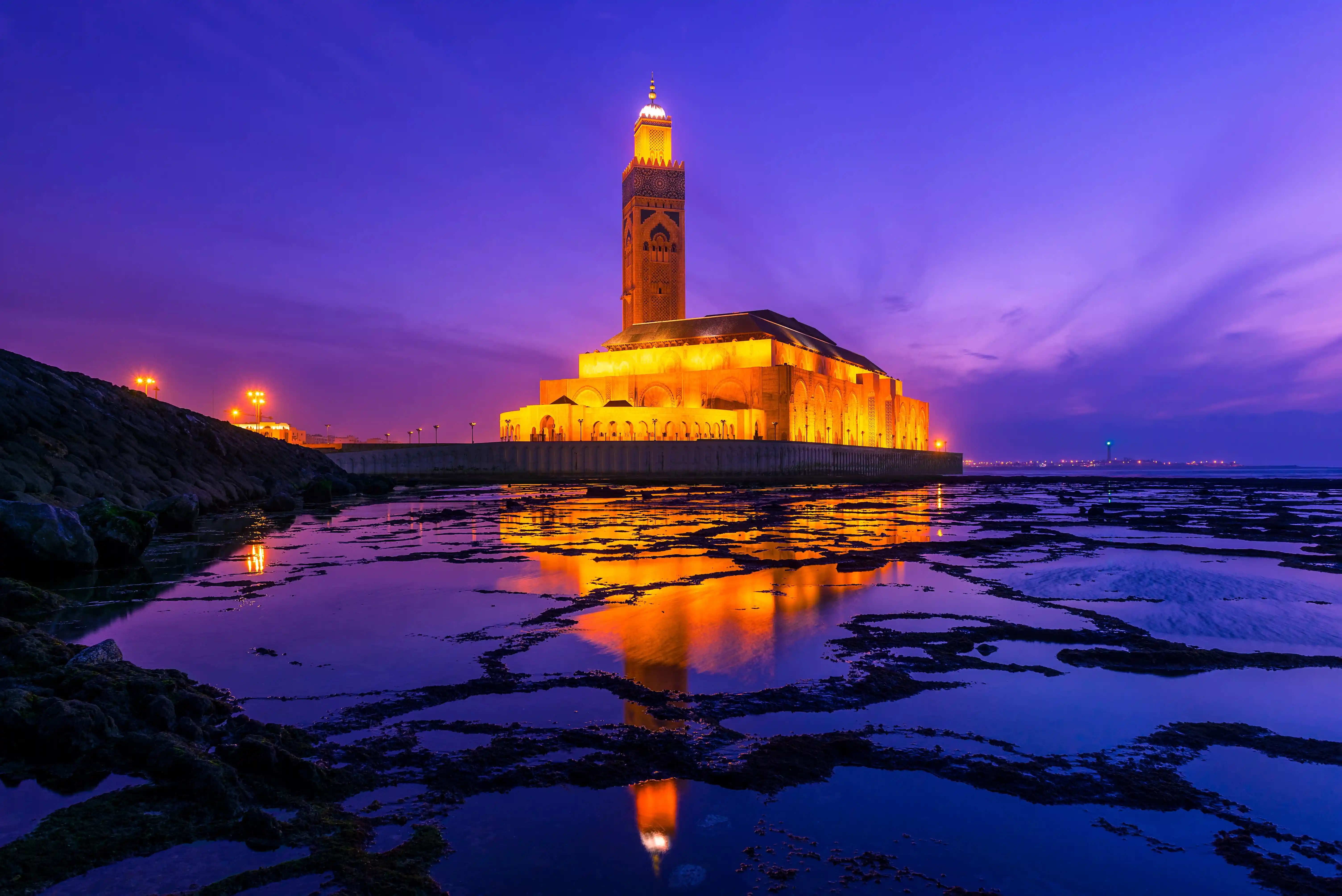 Hassan II Mosque illuminated at dusk on the Atlantic coast in Casablanca, Morocco — featured by Morocco Guided Tours.
